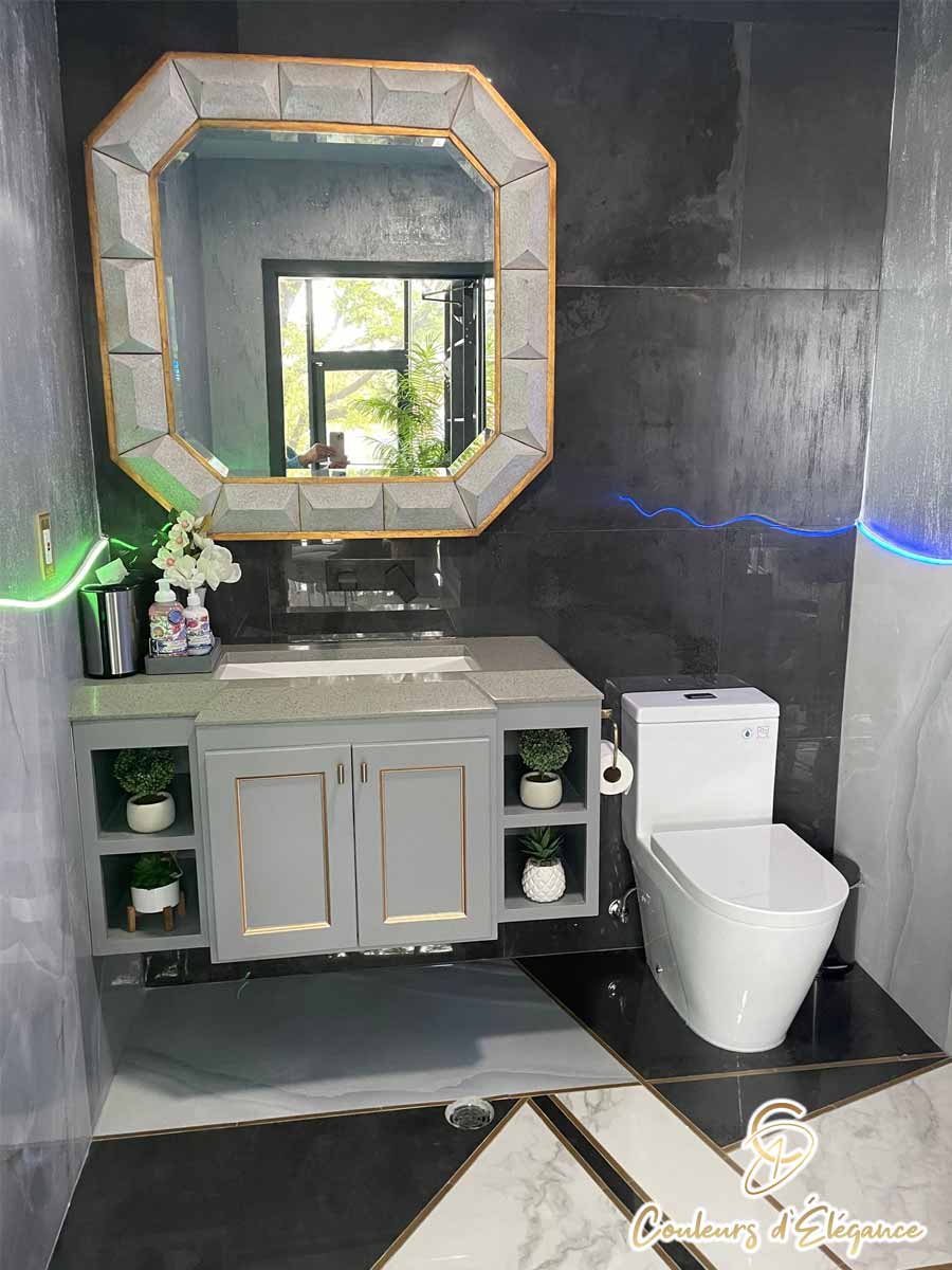 A commercial bathroom featuring various tiles, neon light accents and glitter walls.