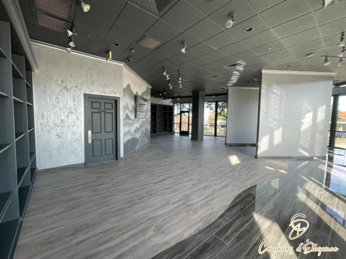 A large commercial space featuring a hand painted forest and mountain mural.