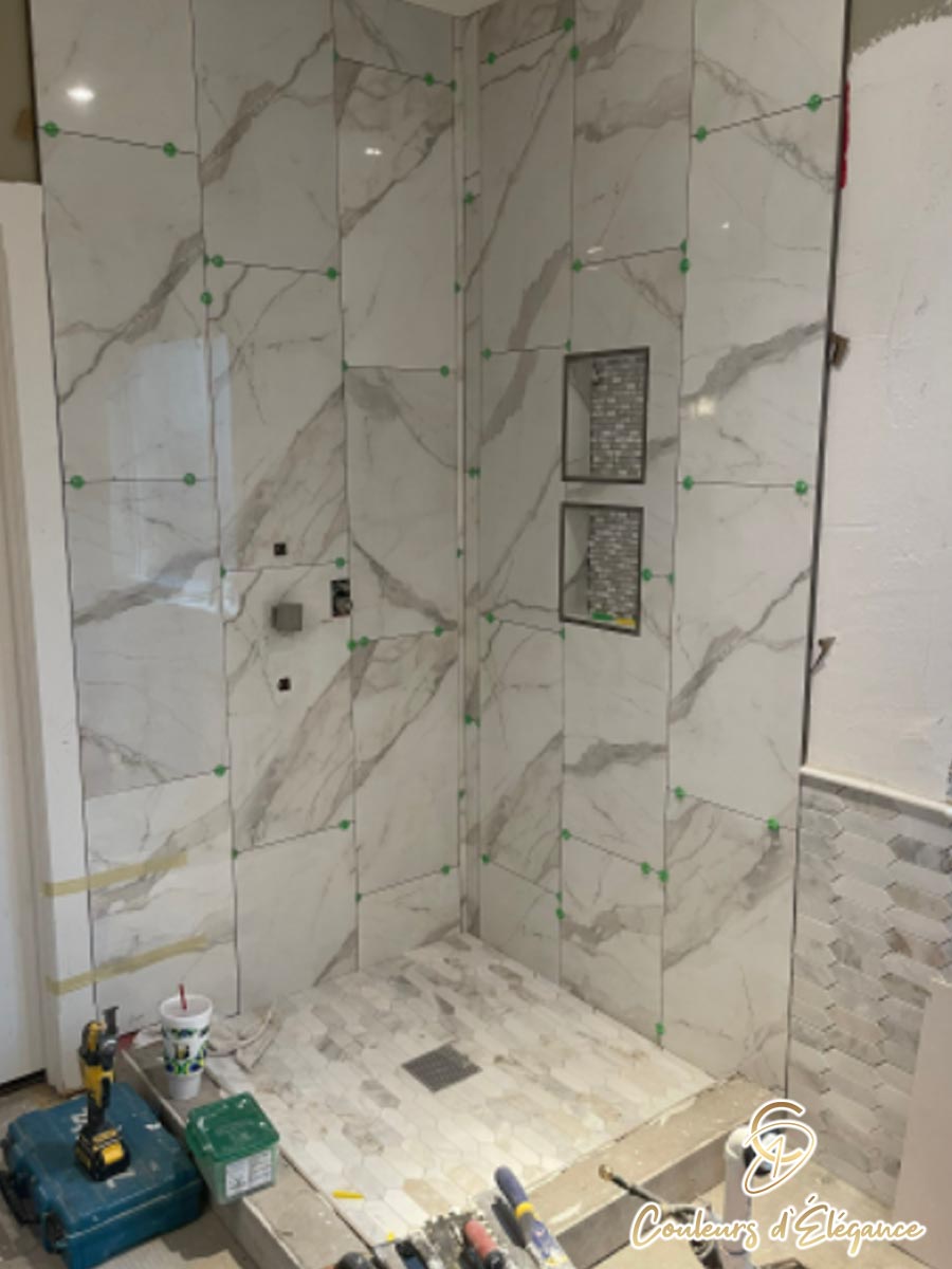 A residential bathroom shower in the process of being tiled.