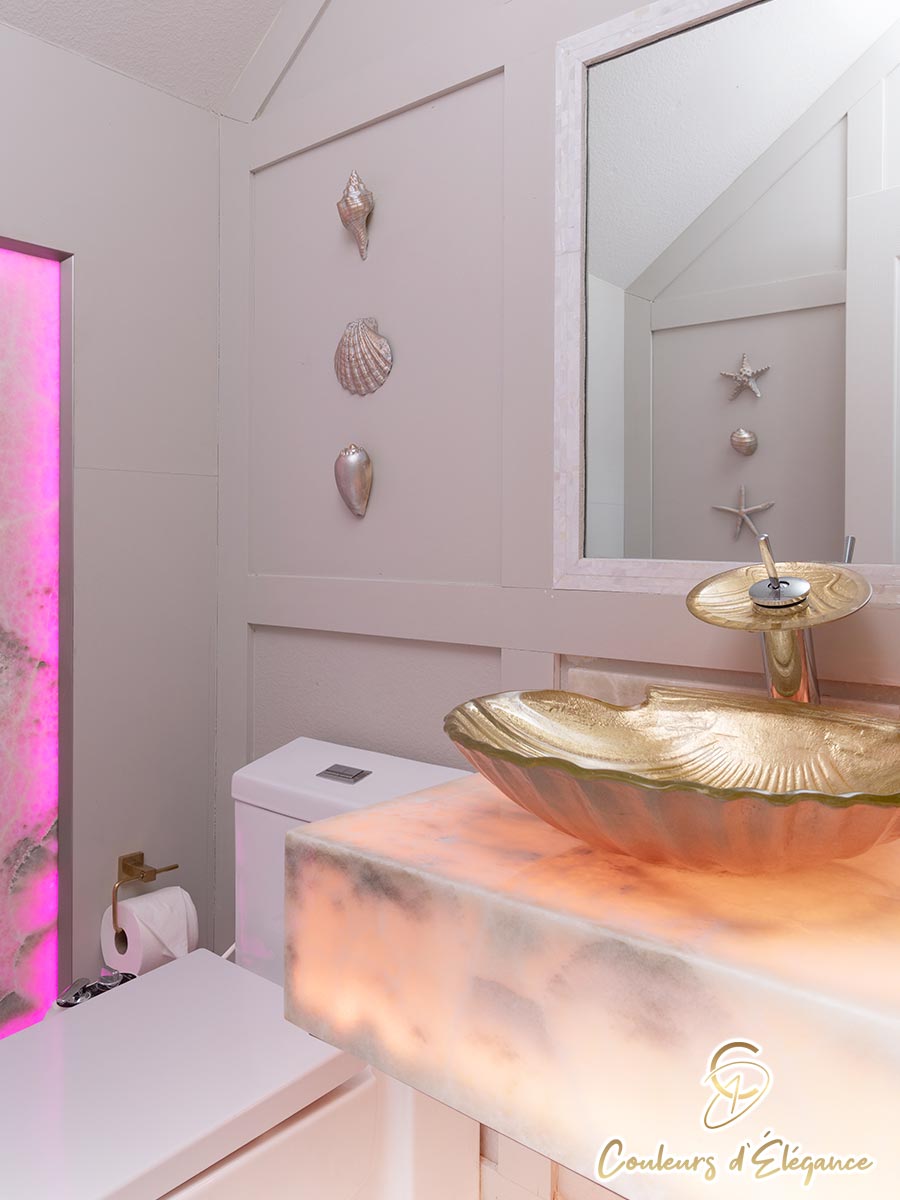 A residential bathroom with a golden seashell sink.