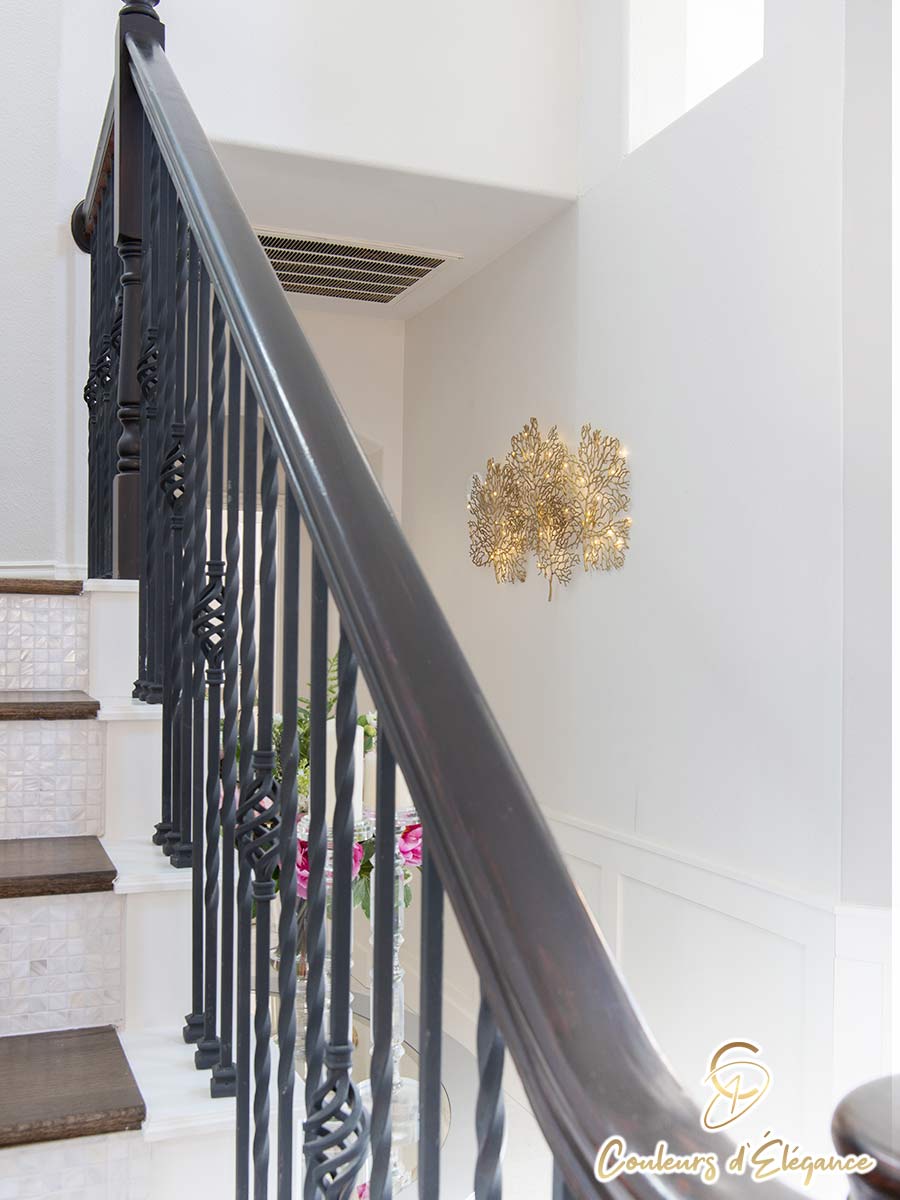 A close up of a black stair banister.