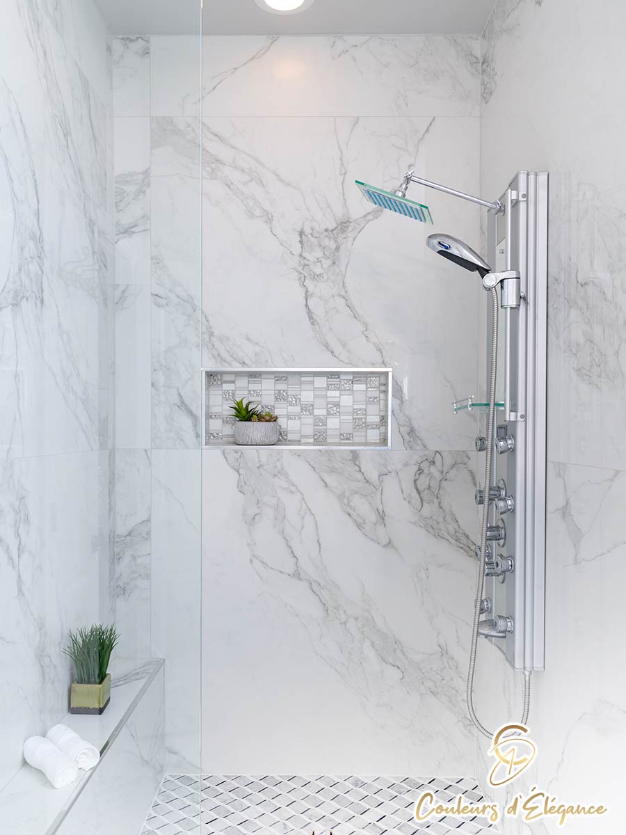 A gorgeous master shower featuring an inset tiled shelf.