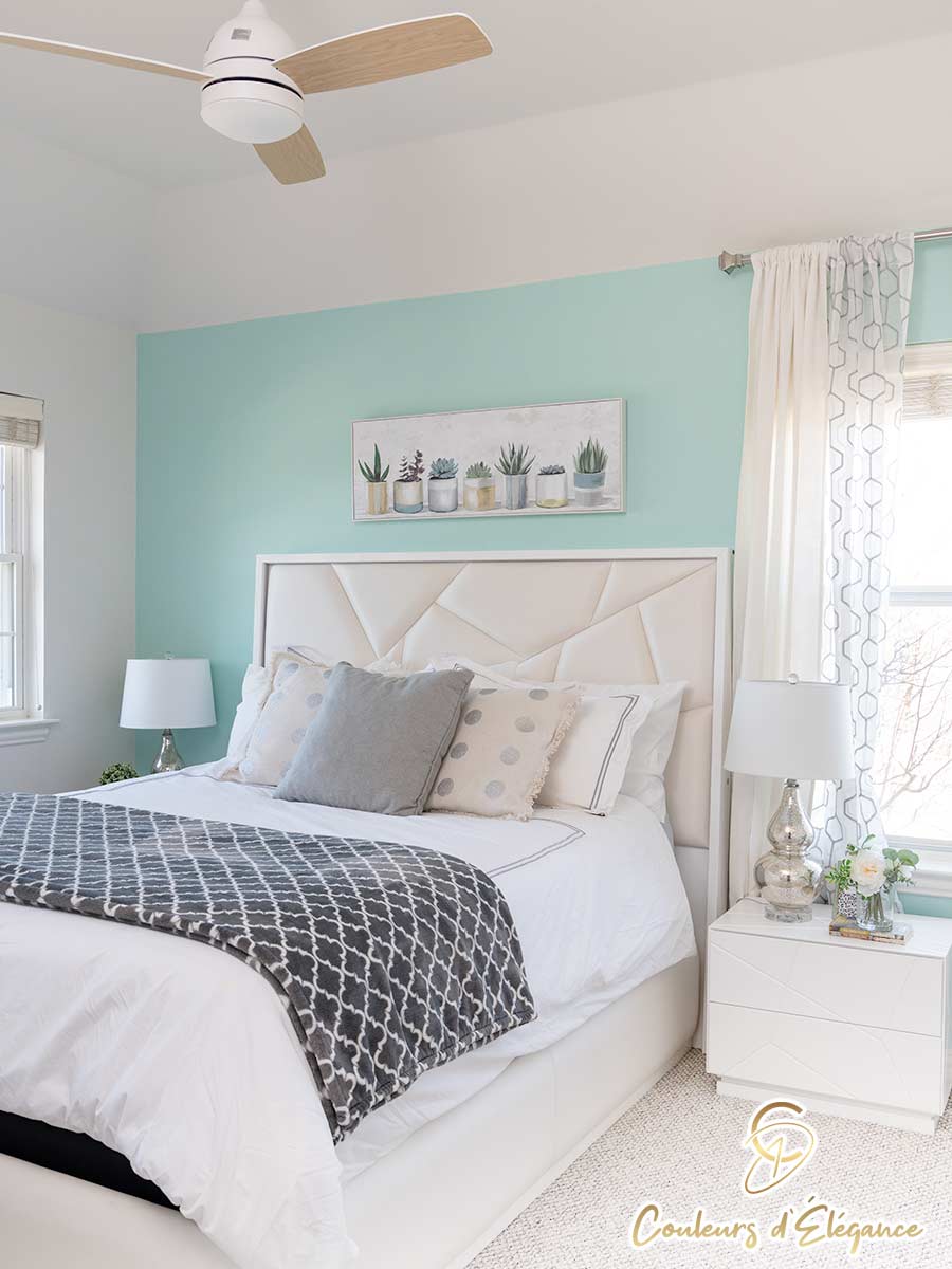 A beautifully designed bedroom with a seafoam feature wall.