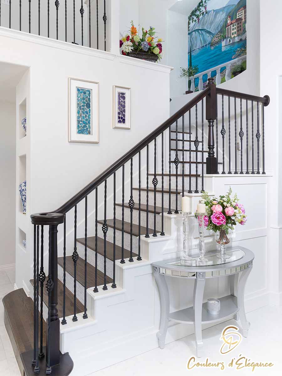 A beautiful staircase leading up to a painted archway.